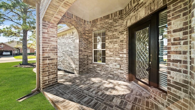 doorway to property featuring a lawn and covered porch