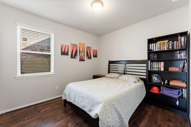 bedroom with dark wood-type flooring