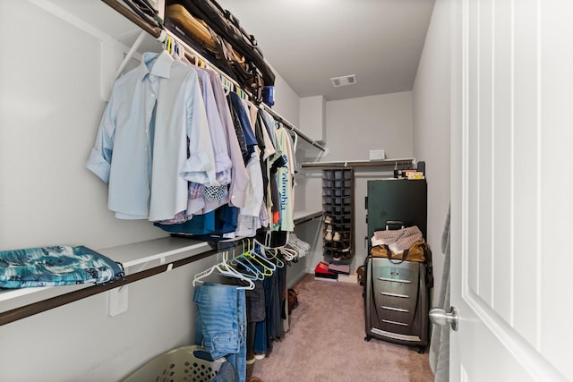 walk in closet featuring light carpet