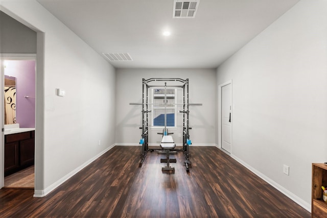 workout room with dark wood-type flooring