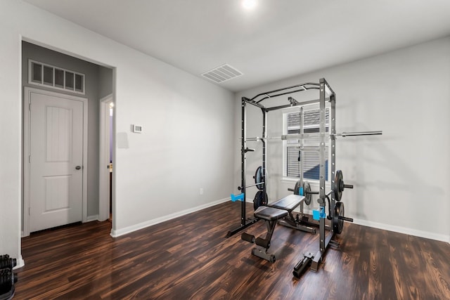 workout area with dark hardwood / wood-style floors