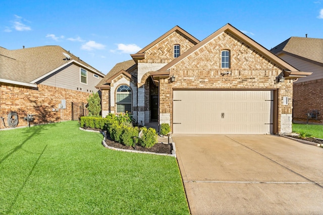 view of front of property with a garage and a front yard