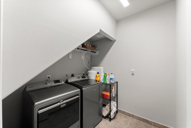 laundry room with light tile patterned floors and separate washer and dryer