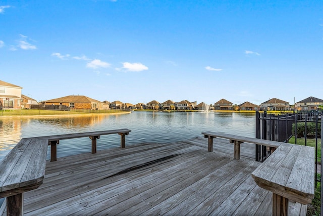 view of dock with a deck with water view