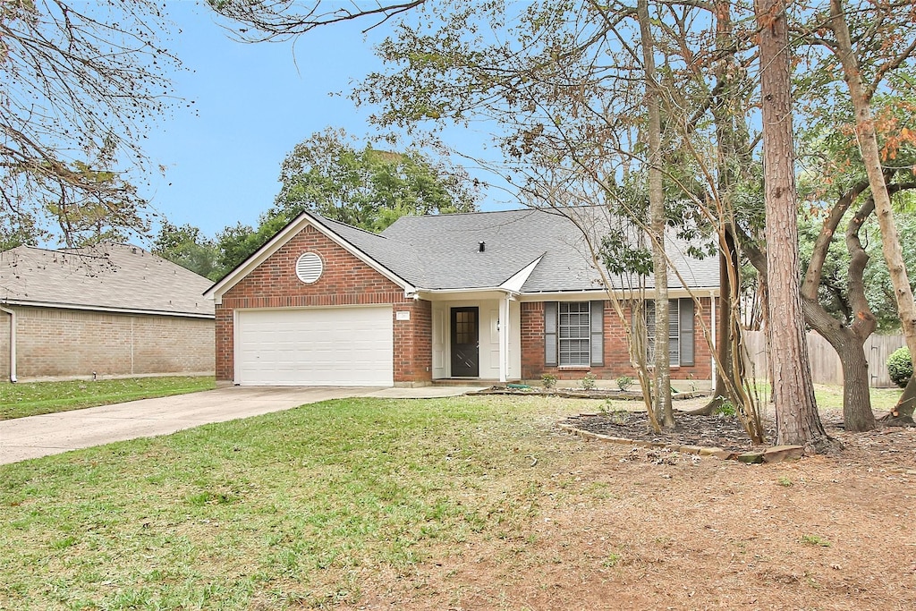 single story home featuring a garage and a front yard