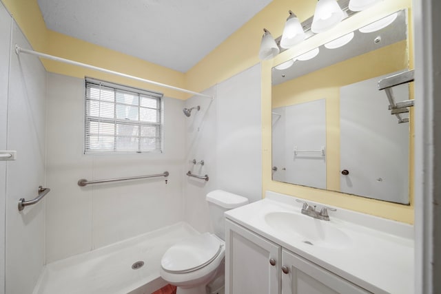 bathroom featuring a shower, vanity, and toilet