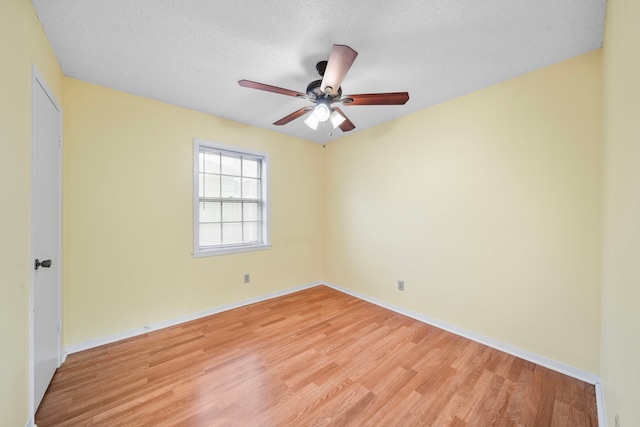 empty room featuring a textured ceiling, light hardwood / wood-style floors, and ceiling fan