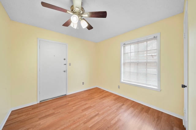 unfurnished room featuring light hardwood / wood-style floors and ceiling fan