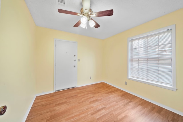 spare room with ceiling fan and light hardwood / wood-style floors