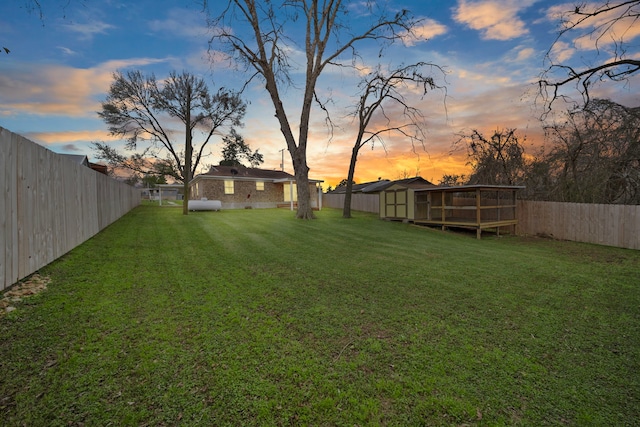 yard at dusk with a wooden deck