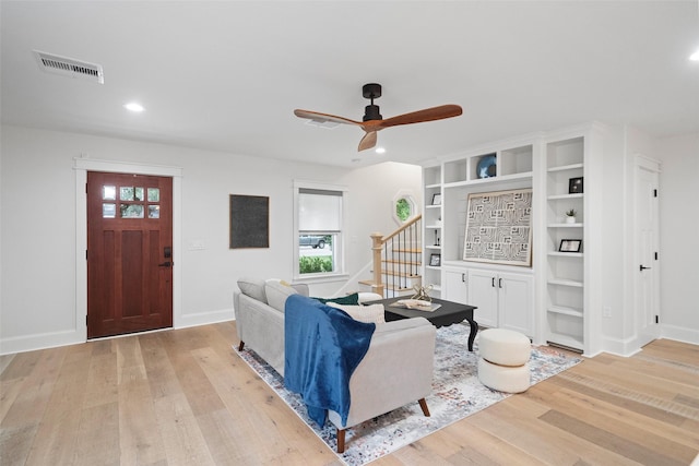 living room featuring ceiling fan and light hardwood / wood-style floors