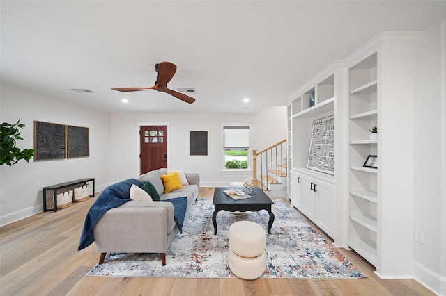 living room featuring light hardwood / wood-style floors and ceiling fan