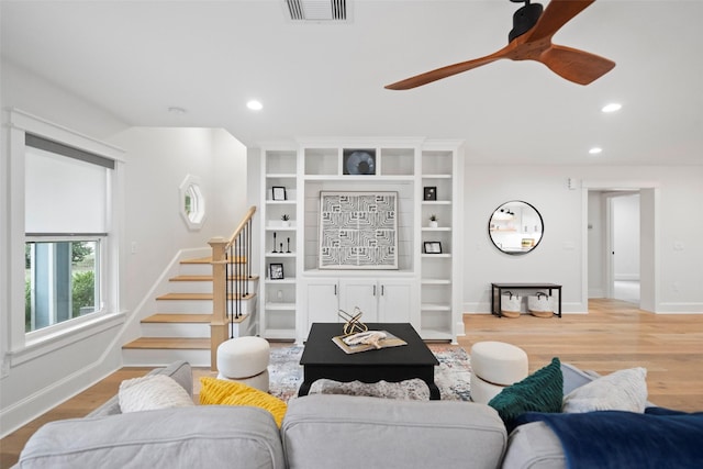 living room with ceiling fan and light hardwood / wood-style floors