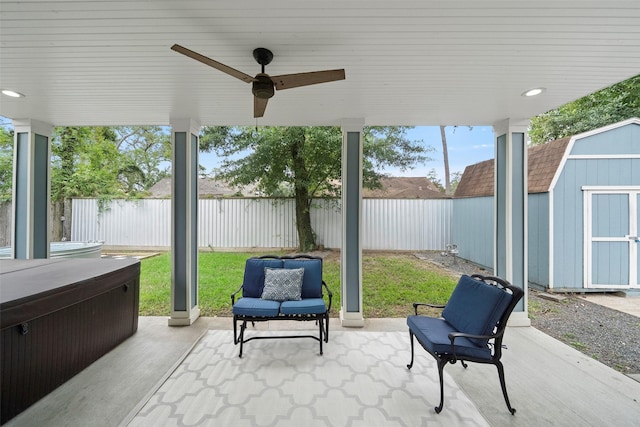 view of patio featuring ceiling fan and a shed