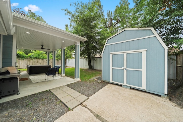 view of patio / terrace with ceiling fan and a storage unit