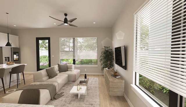 living room with ceiling fan and light hardwood / wood-style floors