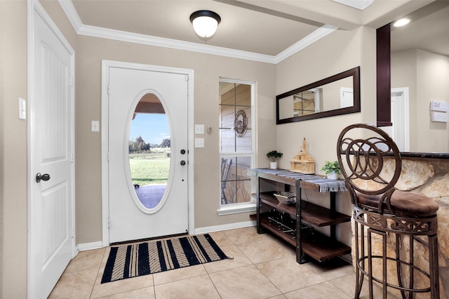 tiled entrance foyer featuring crown molding