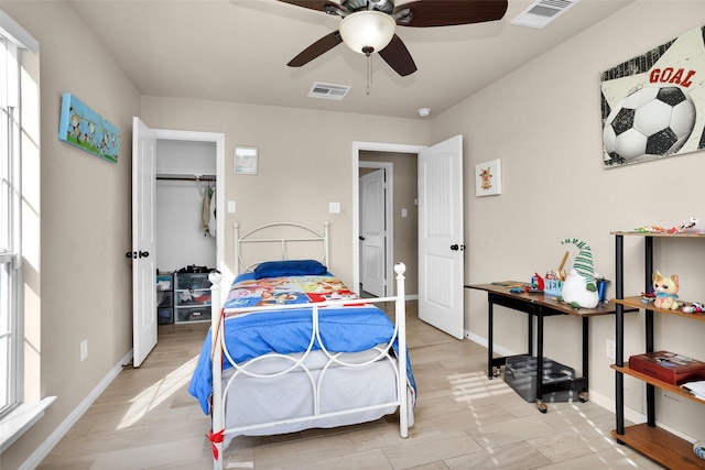 bedroom with ceiling fan, light wood-type flooring, and a closet