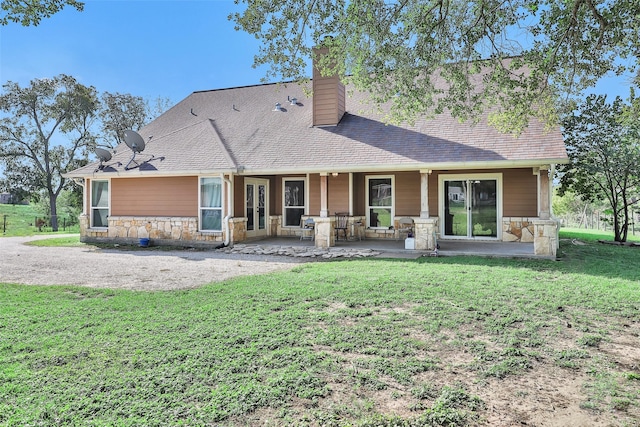 rear view of property with a yard and a patio