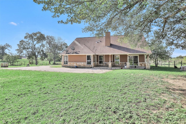 rear view of property featuring a yard