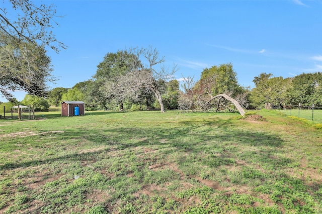 view of yard featuring a rural view and a shed