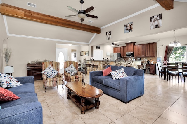 living room featuring a wealth of natural light, light tile patterned floors, lofted ceiling with beams, and ceiling fan with notable chandelier