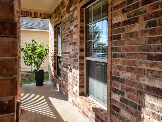 view of exterior entry featuring covered porch