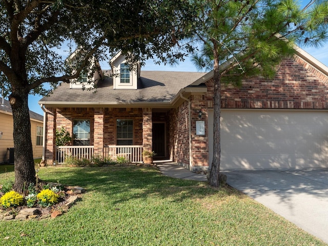 view of front facade featuring a porch, a garage, and a front yard