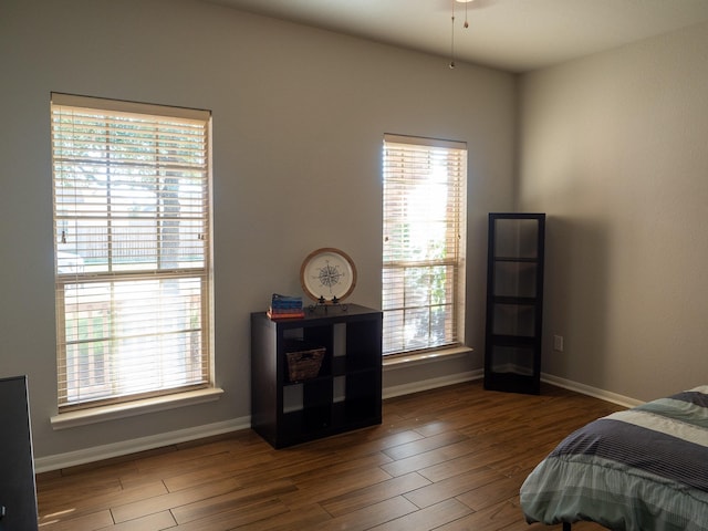 bedroom with dark wood-type flooring