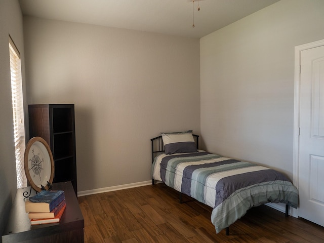 bedroom with dark hardwood / wood-style flooring