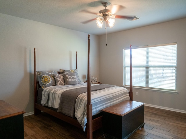 bedroom featuring ceiling fan and dark hardwood / wood-style floors