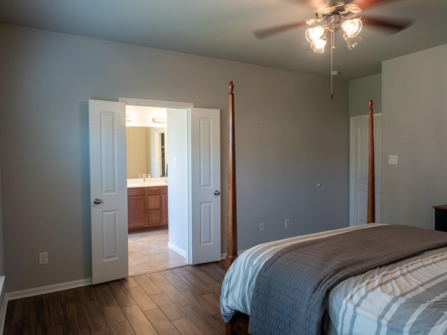 bedroom with ceiling fan, sink, and ensuite bathroom