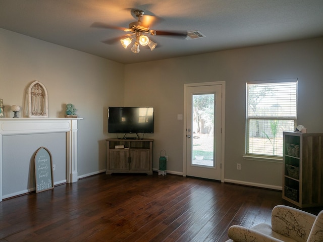 unfurnished living room featuring dark hardwood / wood-style floors and ceiling fan