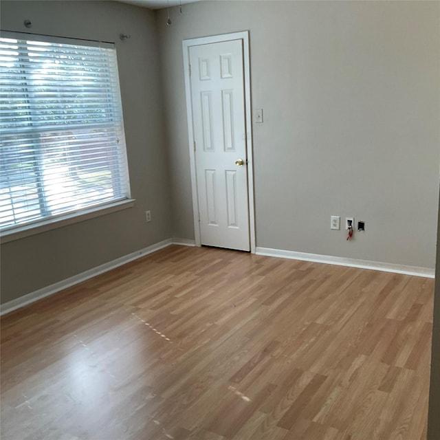 unfurnished room with light wood-type flooring