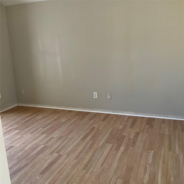 unfurnished room with light wood-type flooring