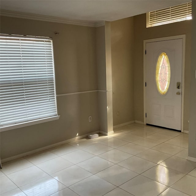 entrance foyer with light tile patterned floors and ornamental molding