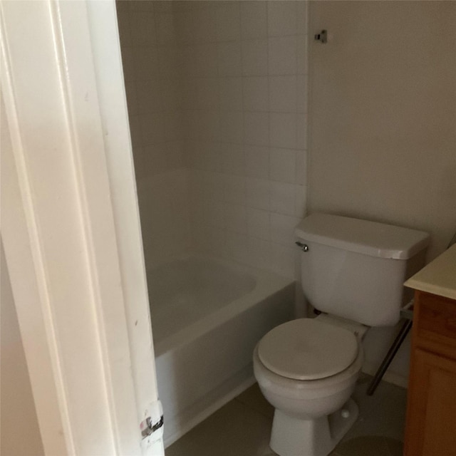 bathroom with vanity, toilet, and a tub to relax in