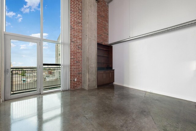 unfurnished living room with a towering ceiling