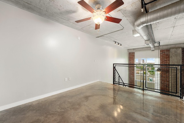 empty room with ceiling fan and concrete floors