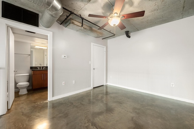 unfurnished bedroom featuring ensuite bath, ceiling fan, and sink