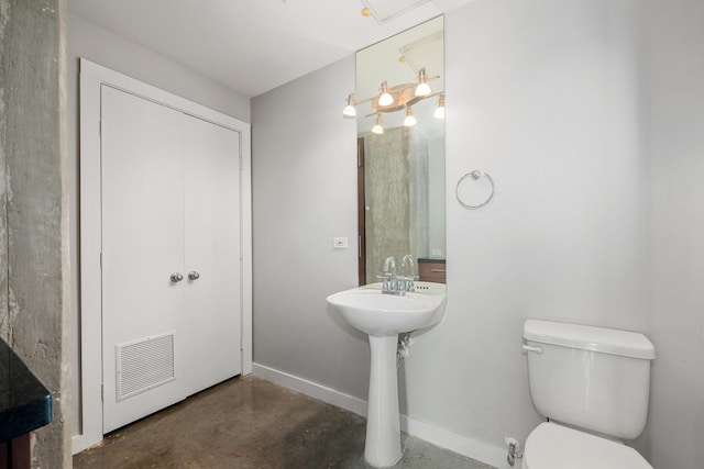 bathroom featuring toilet and concrete floors