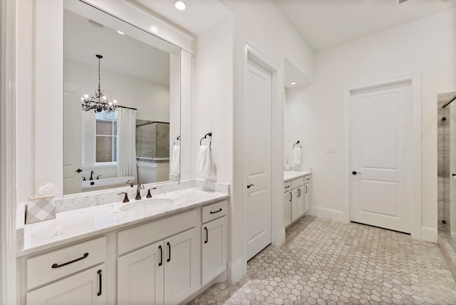 bathroom with tile patterned flooring, vanity, a tub, and a chandelier