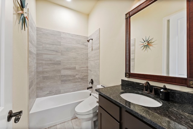 full bathroom with tiled shower / bath combo, toilet, and vanity