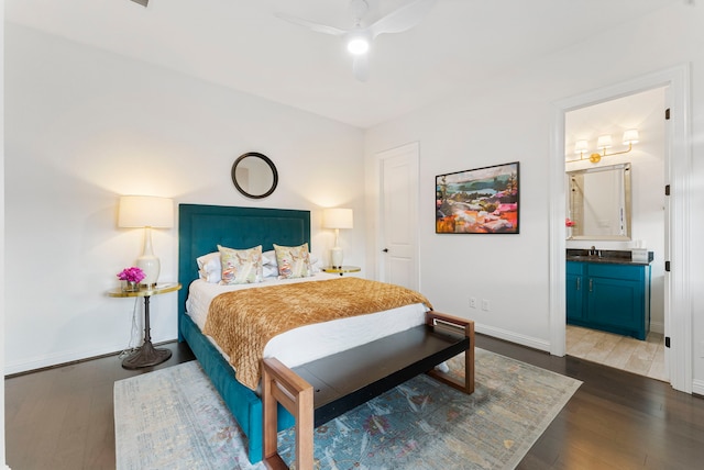 bedroom with ceiling fan, dark hardwood / wood-style floors, sink, and ensuite bath