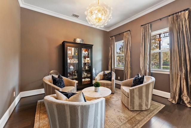 sitting room with ornamental molding, dark hardwood / wood-style floors, a wealth of natural light, and a notable chandelier