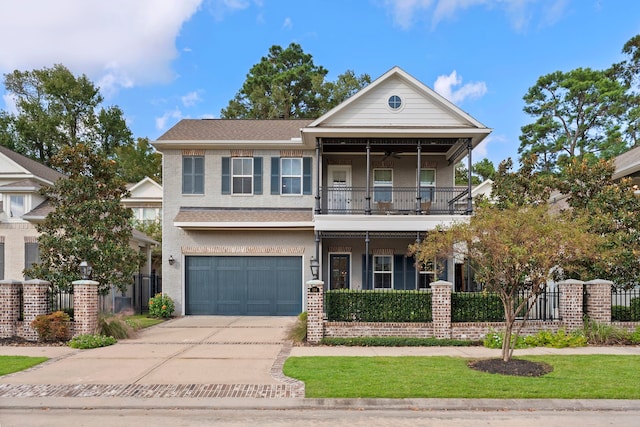 view of front of property featuring ceiling fan, a balcony, and a garage