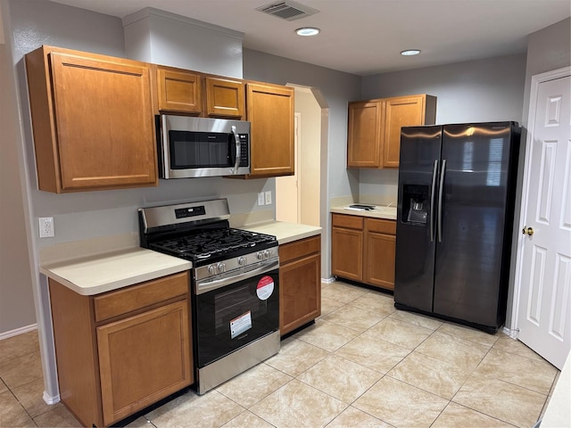 kitchen with light tile patterned flooring and appliances with stainless steel finishes