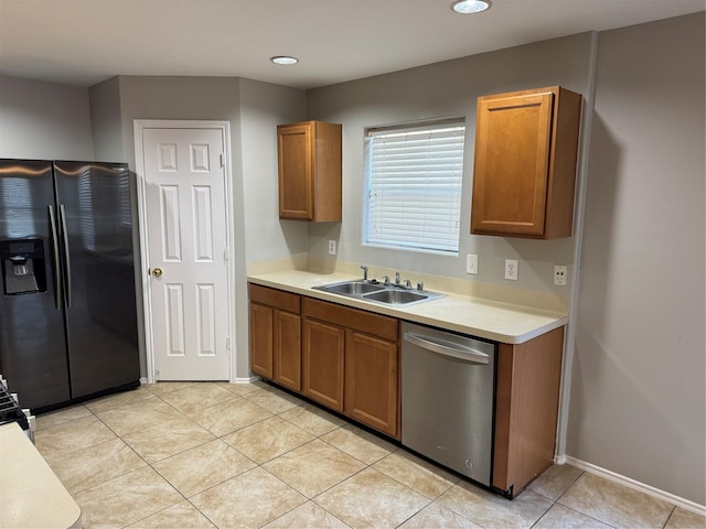 kitchen featuring dishwasher, black fridge with ice dispenser, light tile patterned floors, and sink