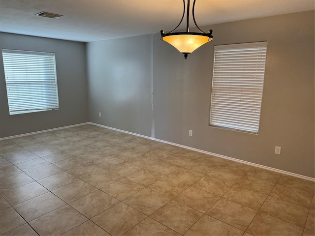 empty room featuring light tile patterned floors