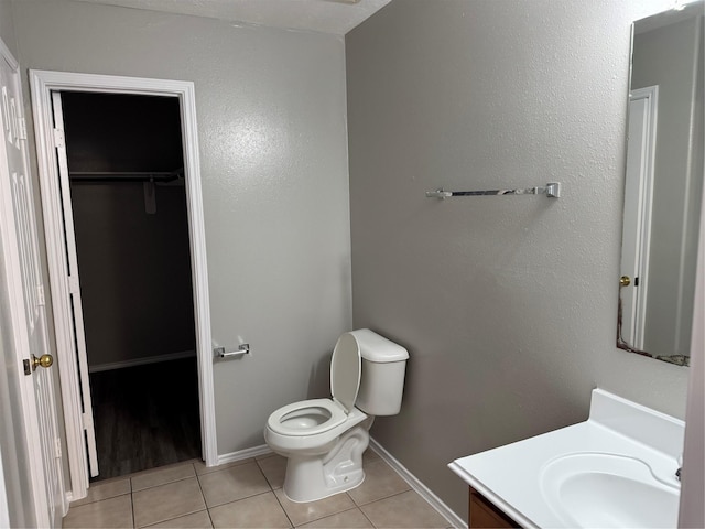 bathroom with tile patterned floors, vanity, and toilet